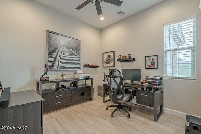 office area with plenty of natural light and ceiling fan