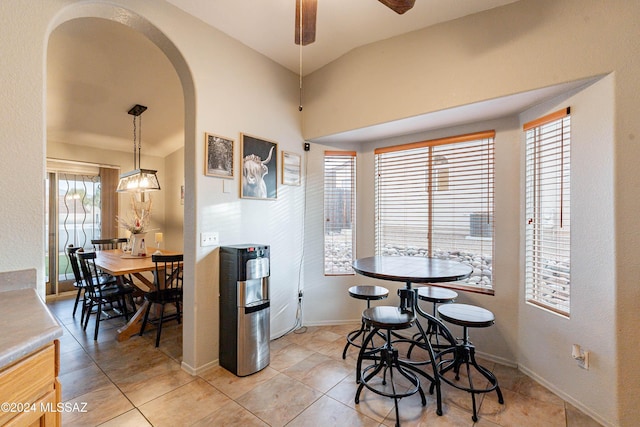 dining space featuring light tile patterned floors, a wealth of natural light, and ceiling fan