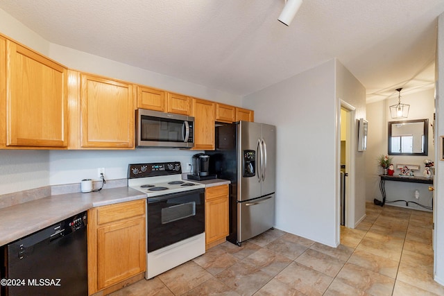 kitchen featuring decorative light fixtures, a textured ceiling, and stainless steel appliances