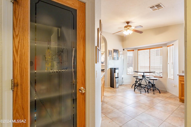 kitchen with ceiling fan and light tile patterned flooring