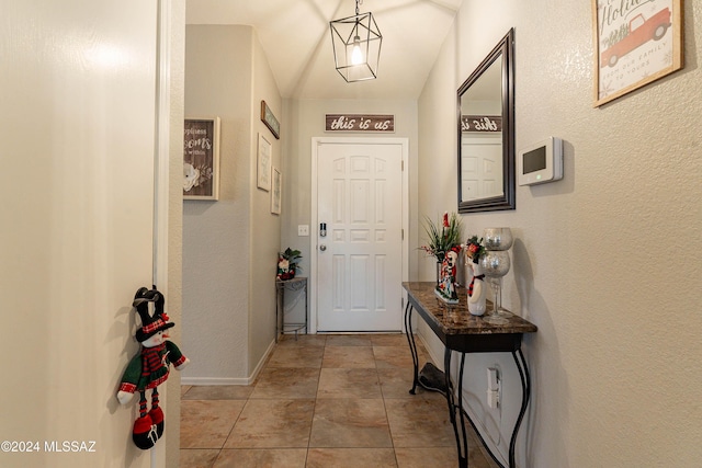 doorway to outside with light tile patterned floors