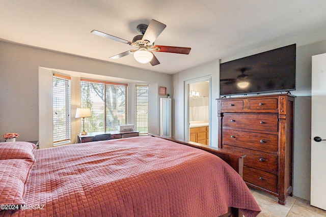 tiled bedroom featuring ceiling fan and connected bathroom