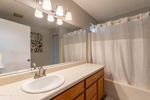 bathroom featuring vanity and shower / bath combination with curtain