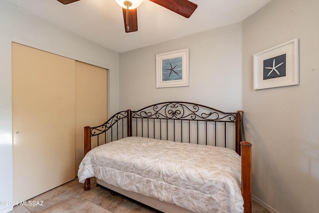 bedroom featuring ceiling fan, a closet, and hardwood / wood-style flooring