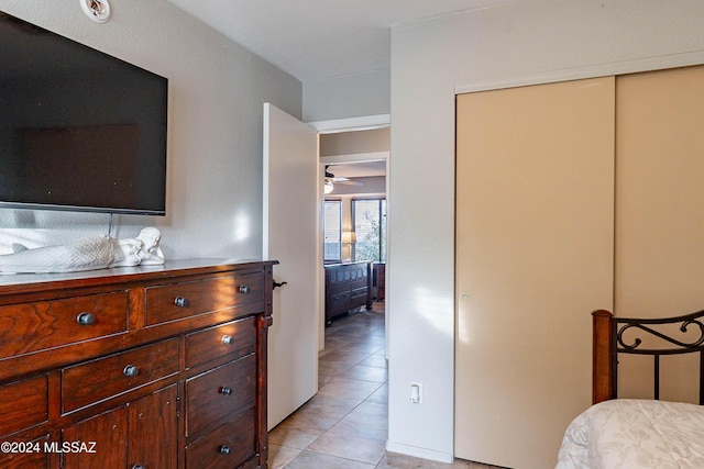 tiled bedroom featuring a closet