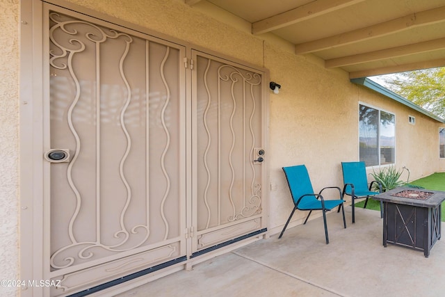 view of exterior entry with a patio