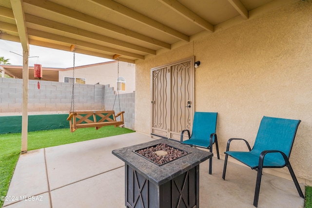 view of patio / terrace featuring an outdoor fire pit