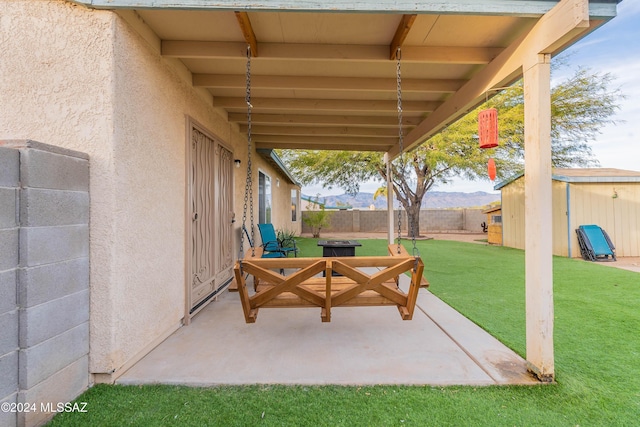 view of patio / terrace featuring a mountain view and a storage unit