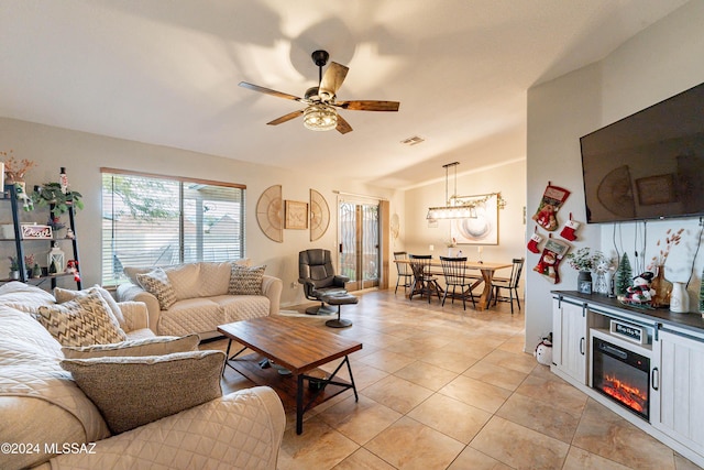 living room featuring ceiling fan and light tile patterned floors