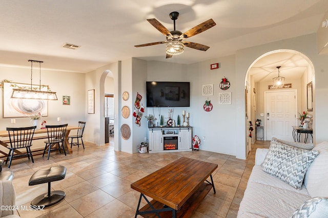 living room featuring ceiling fan and light tile patterned floors