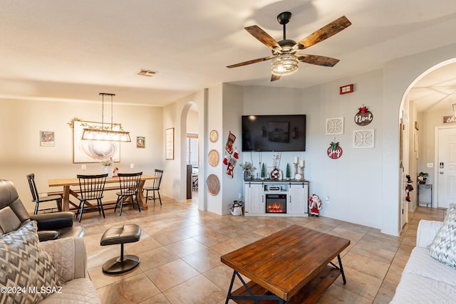 tiled living room with ceiling fan