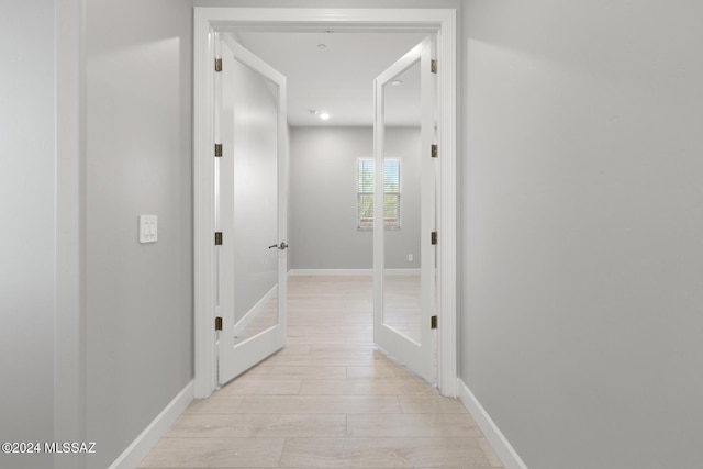 hallway with light hardwood / wood-style flooring