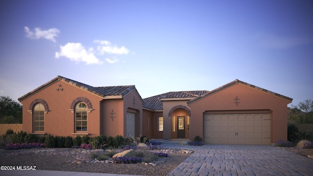 mediterranean / spanish-style home featuring a garage