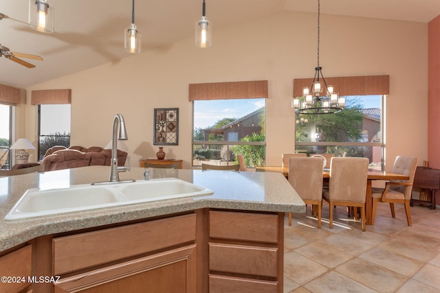 63645 E Vacation Dr, Tucson, AZ 85739 - kitchen with hanging light fixtures, a sink, open floor plan, vaulted ceiling, and ceiling fan with notable chandelier