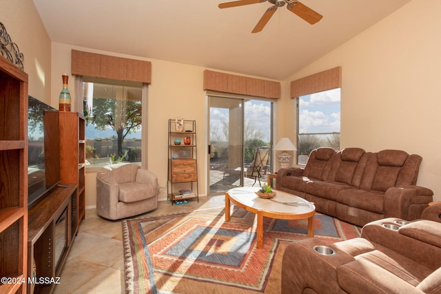 tiled living room with ceiling fan and lofted ceiling