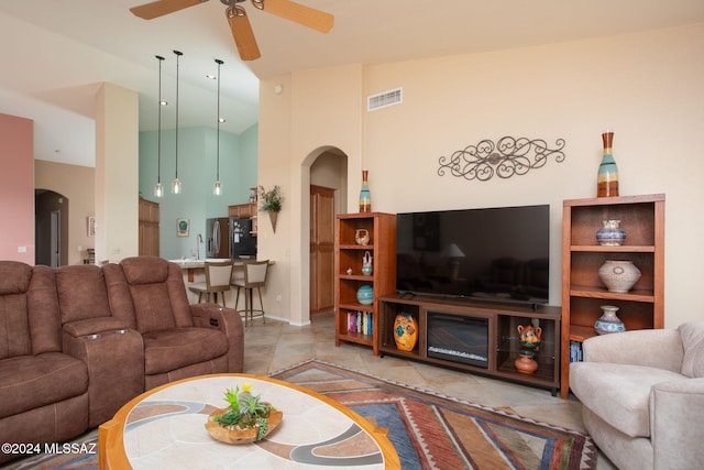 63645 E Vacation Dr, Tucson, AZ 85739 - tiled living area with high vaulted ceiling, arched walkways, visible vents, and a ceiling fan