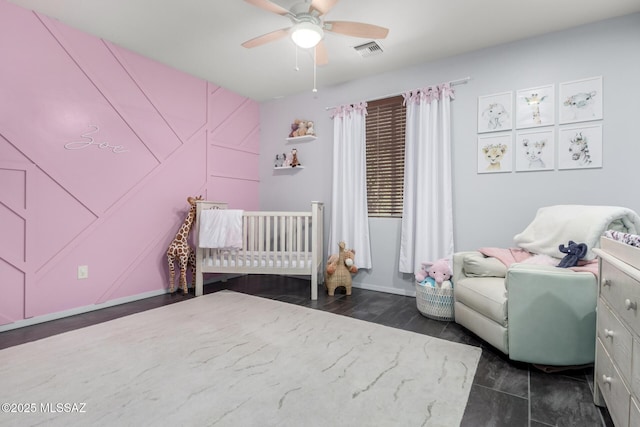 bedroom featuring ceiling fan and a crib