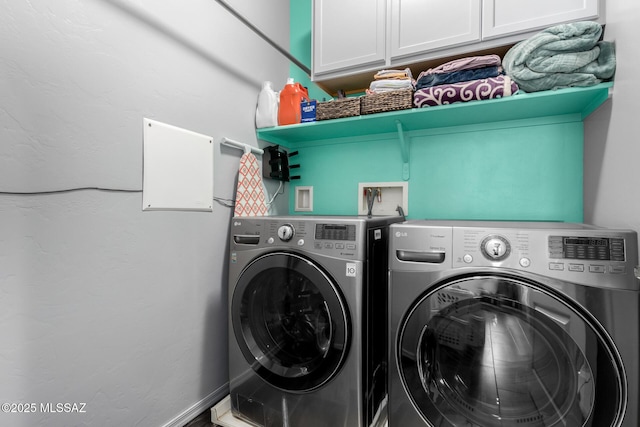 clothes washing area featuring cabinets and washing machine and clothes dryer