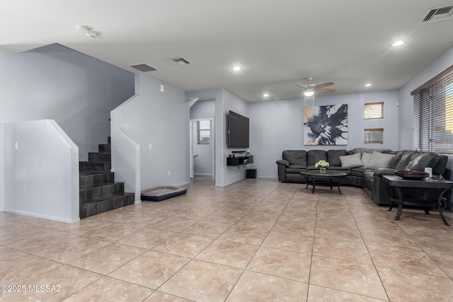 tiled living room featuring ceiling fan