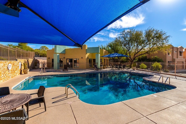 view of swimming pool featuring a patio area