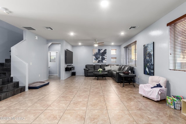 tiled living room featuring ceiling fan and plenty of natural light