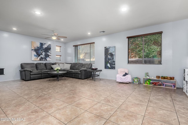 living room featuring a wealth of natural light, light tile patterned flooring, and ceiling fan