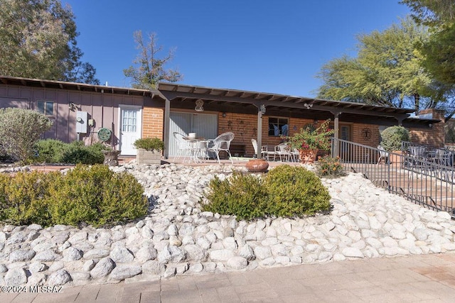 rear view of property with covered porch