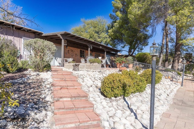 exterior space with fence and covered porch