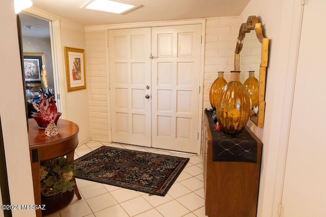 foyer entrance with light tile patterned flooring