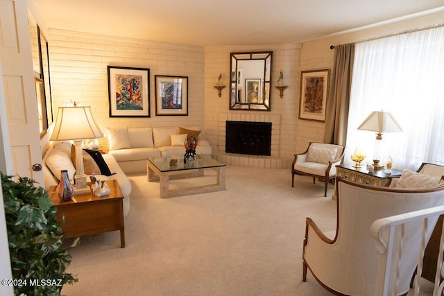 living room with carpet floors, brick wall, and a brick fireplace