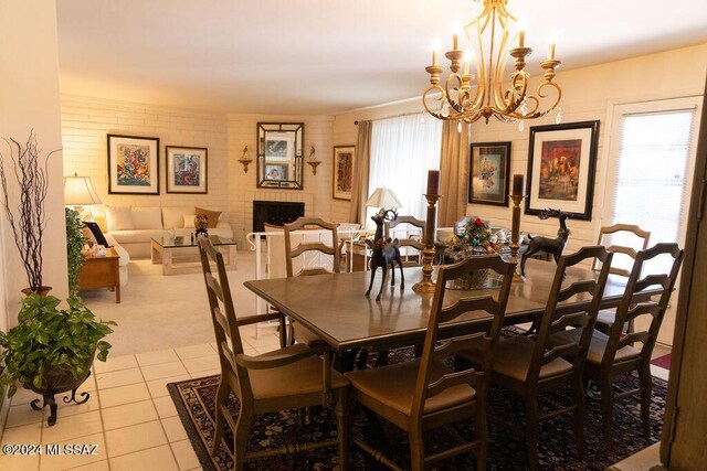 tiled dining space featuring a notable chandelier and a fireplace