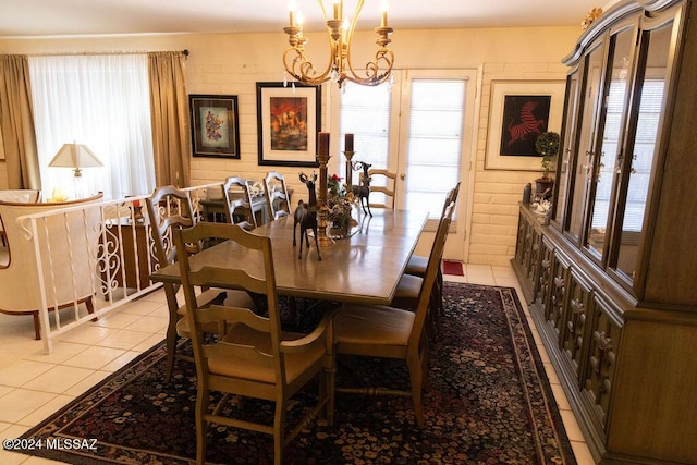 dining room with light tile patterned flooring, plenty of natural light, and an inviting chandelier