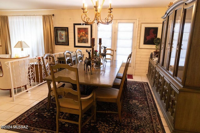 tiled dining room with a notable chandelier