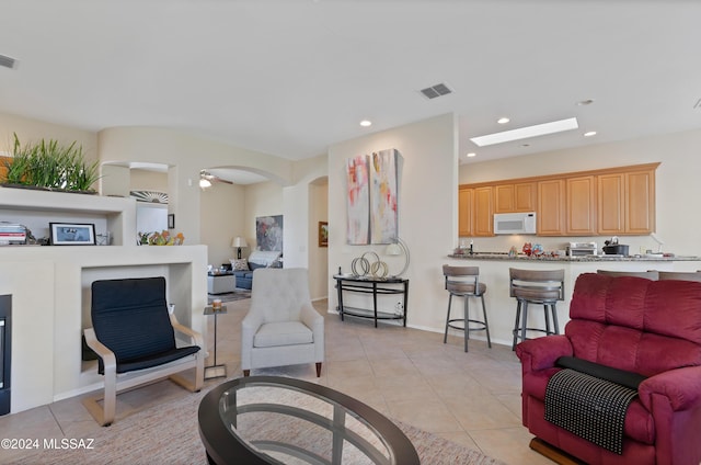 tiled living room with ceiling fan