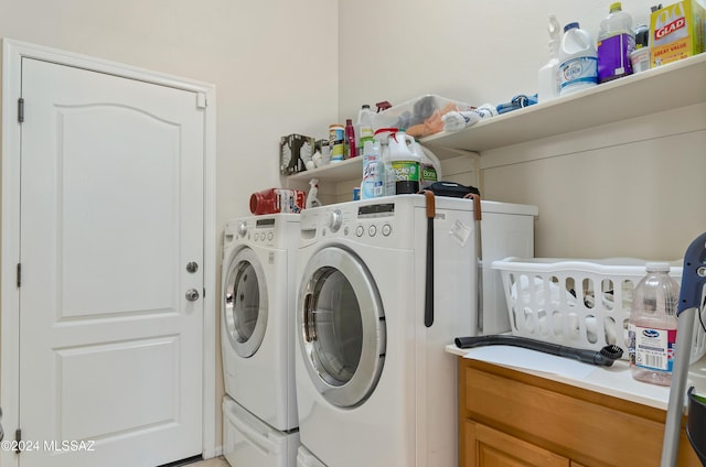 clothes washing area with washing machine and dryer