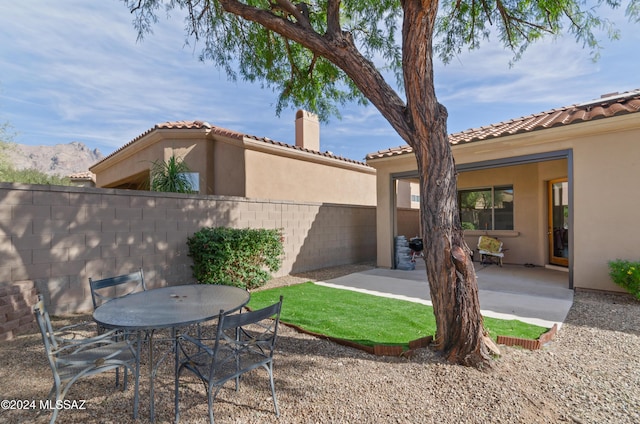 view of yard with a mountain view and a patio