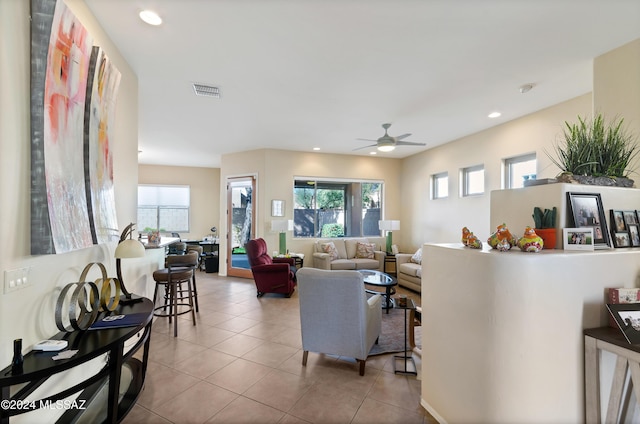 living room featuring ceiling fan and light tile patterned flooring