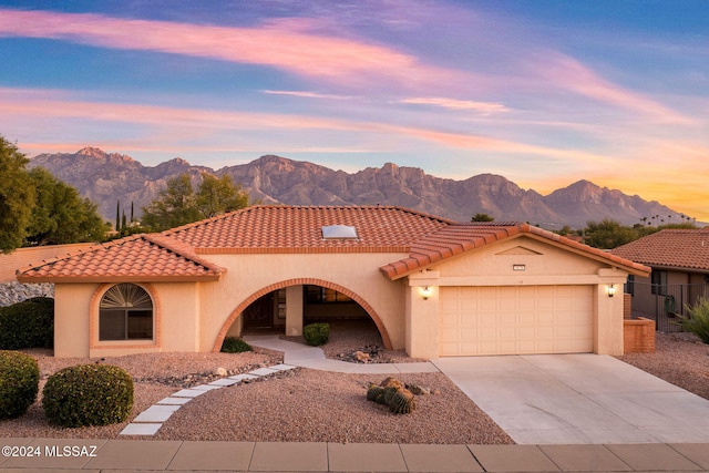 mediterranean / spanish house featuring a mountain view and a garage