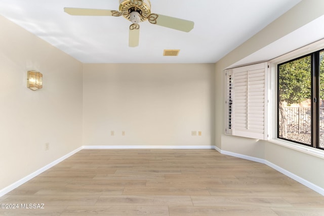 empty room featuring light hardwood / wood-style flooring, plenty of natural light, and ceiling fan