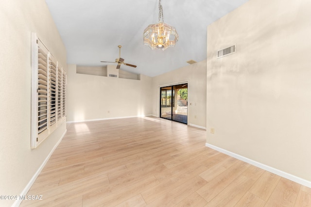 unfurnished living room featuring ceiling fan with notable chandelier, light hardwood / wood-style floors, and lofted ceiling