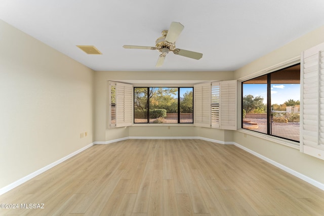 empty room featuring ceiling fan and light hardwood / wood-style flooring