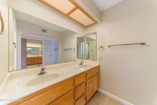 bathroom featuring vanity and wood-type flooring