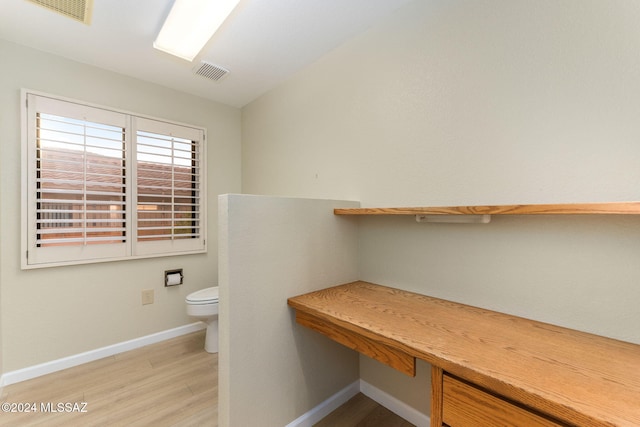 bathroom featuring hardwood / wood-style floors and toilet