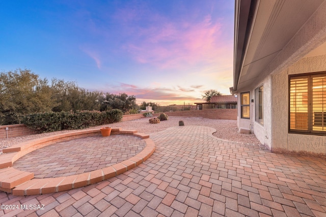 view of patio terrace at dusk