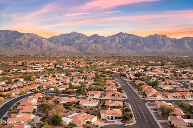 aerial view at dusk featuring a mountain view