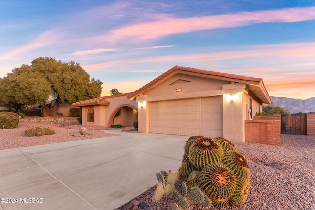 view of front of home with a mountain view and a garage