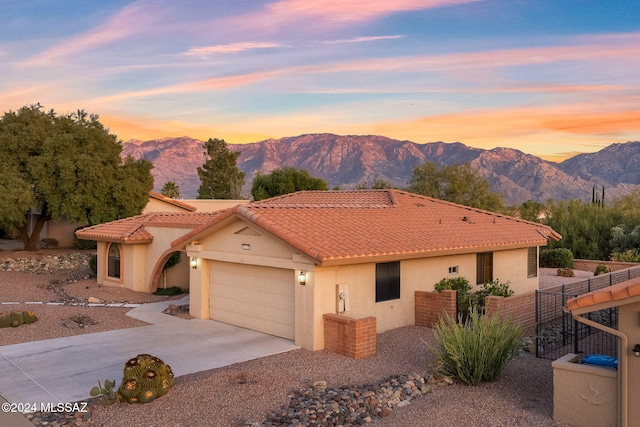 view of front facade with a mountain view and a garage