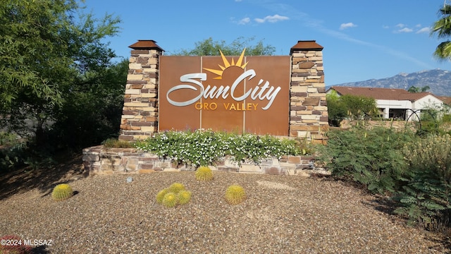 community sign with a mountain view