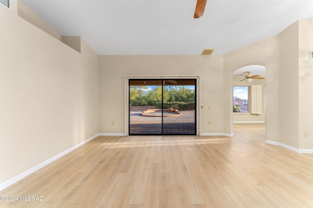 empty room with ceiling fan and light hardwood / wood-style flooring