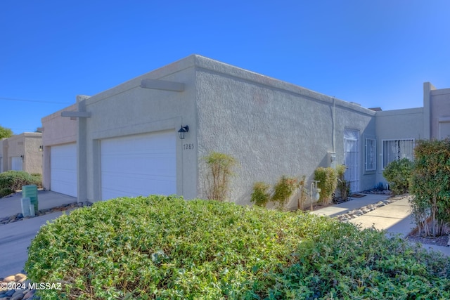 view of side of home with a garage